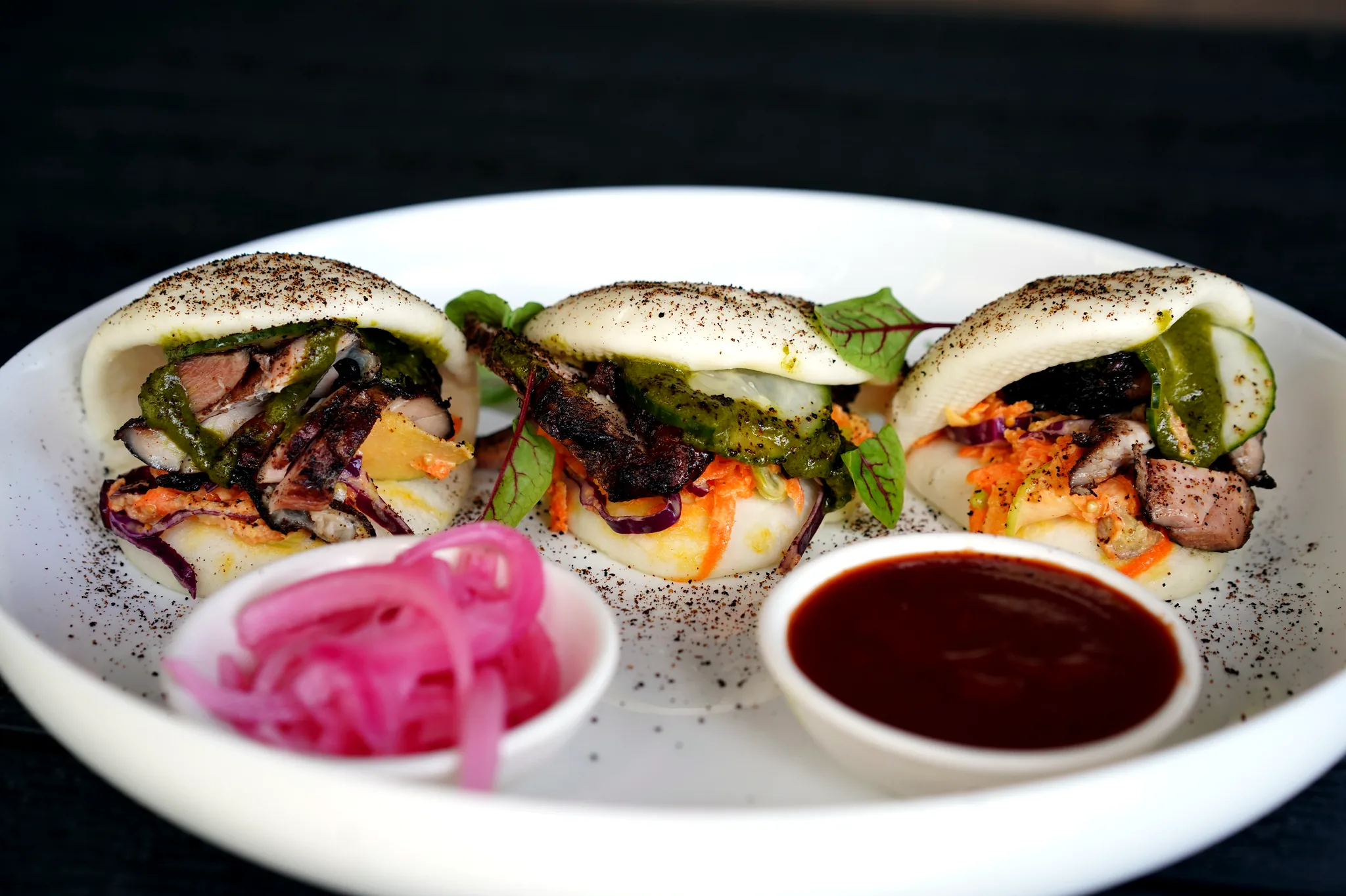 Jerk chicken bao with pickled onion and sauce at SoLo on Main
